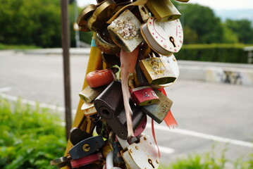 Wedding locks on a fence. Vintage padlock is located on the metal fence.