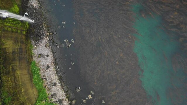 Aerial view of a waterfall along the coast, Driftwood Bay, Unalaska Island, Alaska, United States.