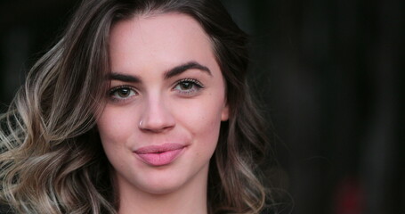 Naklejka premium Flirtatious beautiful blonde hispanic young woman looking to camera smiling