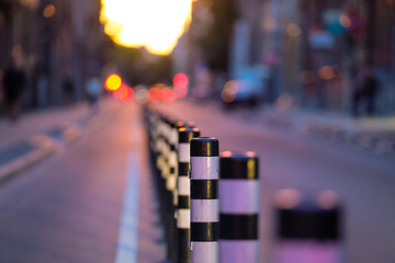 Separate bicycle lane for riding bicycles separated by bars. Selective focus