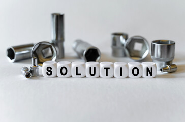 On a white background, a set with tools and white cubes with the inscription - Solution