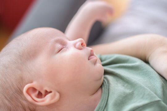 Cute detail macro portrait view of peaceful baby head face, calm sleeps soundly. Beautiful child sleeping and resting
