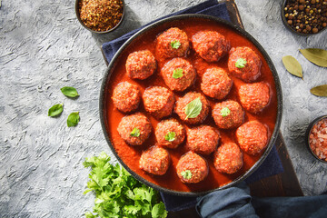 Middle Eastern traditional spiced meatballs in tomato sauce "Dawood Basha". Top view with copy space.