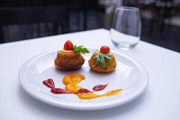 dish presented artistically on a plate with different sauces