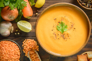 Arabic Cuisine; Middle Eastern traditional red lentil soup with fresh ingredients. Top view with close up.