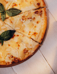 Pizza quattro fromaggi on a wooden table