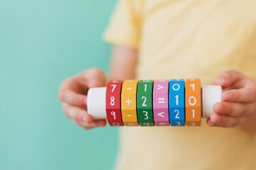 Boy with arithmetic math learning toy