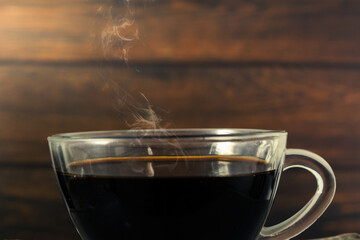 glass cup with black coffee and hot smoke