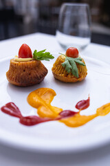 dish presented artistically on a plate with different sauces