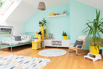 Cozy interior of room child with pastel color on the wall and yellow color in decor. Room in the...