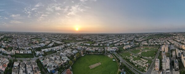180 degree Aerial view of housing society and its cricket ground at dusk, lahore, Pakistan.