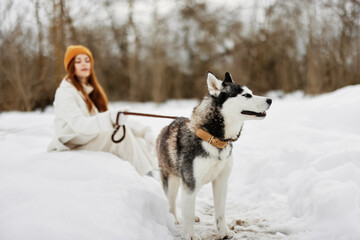 young woman winter outdoors with a dog fun nature winter holidays