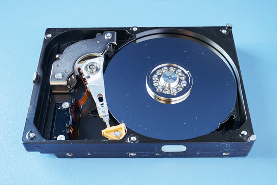 Disassembled computer hard disk drive with dust, close-up. Broken tightness of the hard drive. HDD repair, Data Recovery. The concept of  data protection.