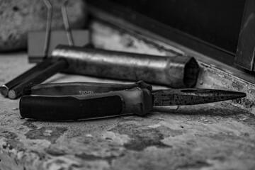 close-up detail of tools. Alicante in black and white. screwdriver between a machine.