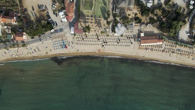 Aerial view of a small beach along the coast with parasols in summertime, Procchio, Elba Island, Italy.