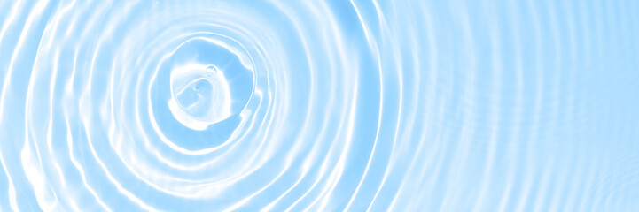 The surface of light on the light blue transparent swimming pool water background. Abstract wavy background. Water waves in sunlight banner. Trendy banner for cosmetic facial concept