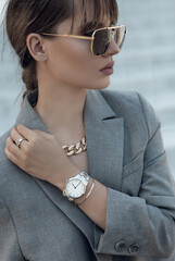 Beautiful stylish white watch on woman hand. Portrait of beautiful woman with stylish silver watch...