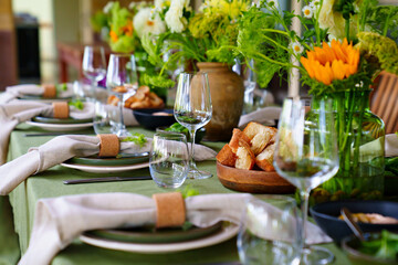 beautiful setting of a large table with flowers. 