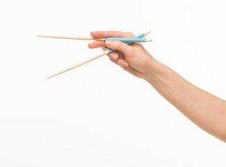 hand holding chopsticks on white background isolated