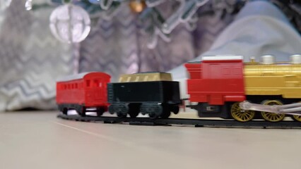 Christmas train traveling under a Christmas tree with gift bag and presents - Powered by Adobe