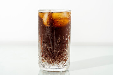 A glass of iced cola on a hot summer day