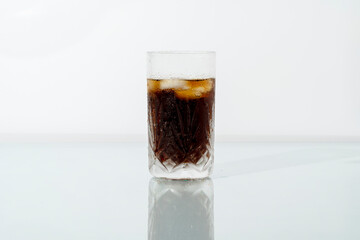 A glass of iced cola on a hot summer day