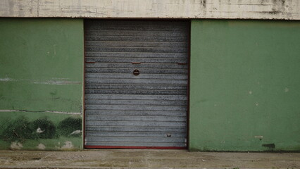 garage metal door on green facade