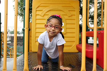 Little brunette latin woman girl with glasses plays outdoors in free games, happy, doing physical activity
