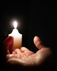 Hand holding candle