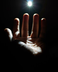 hand reaching toward light