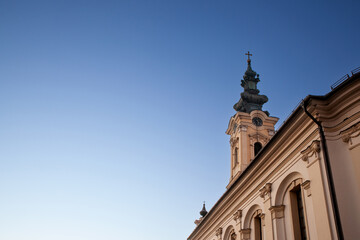 Fototapeta na wymiar Steeple tower of hram uspenja presvete bogorodice, the Serbian orthodox Church of Crepaja a 19th century old Austro Hungarian style church, with its typical baroque clocktower. ....