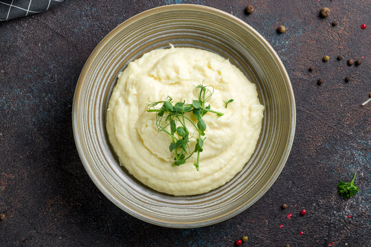 mashed potatoes on bowl on dark stone table top view