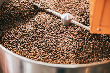 Close up of coffee beans in coffee roasting machine in a small manufacturing