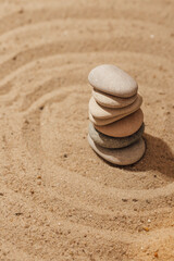 Fototapeta na wymiar stones stack on sand, zen meditation