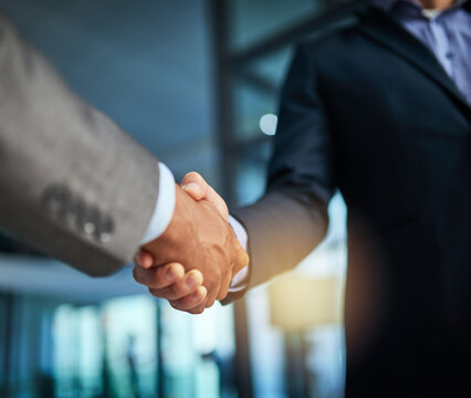 Handshake, teamwork and collaboration with businessmen congratulating with hand gesture on success for a sealed deal or agreement. HR manager hiring employee or partner after a successful interview