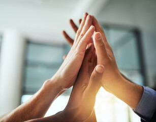High five of a diverse group of businesspeople celebrate, unite and support each other. Closeup of...