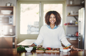 Health, wellness and food of a healthy lifestyle, portrait of happy black woman cooking in a...