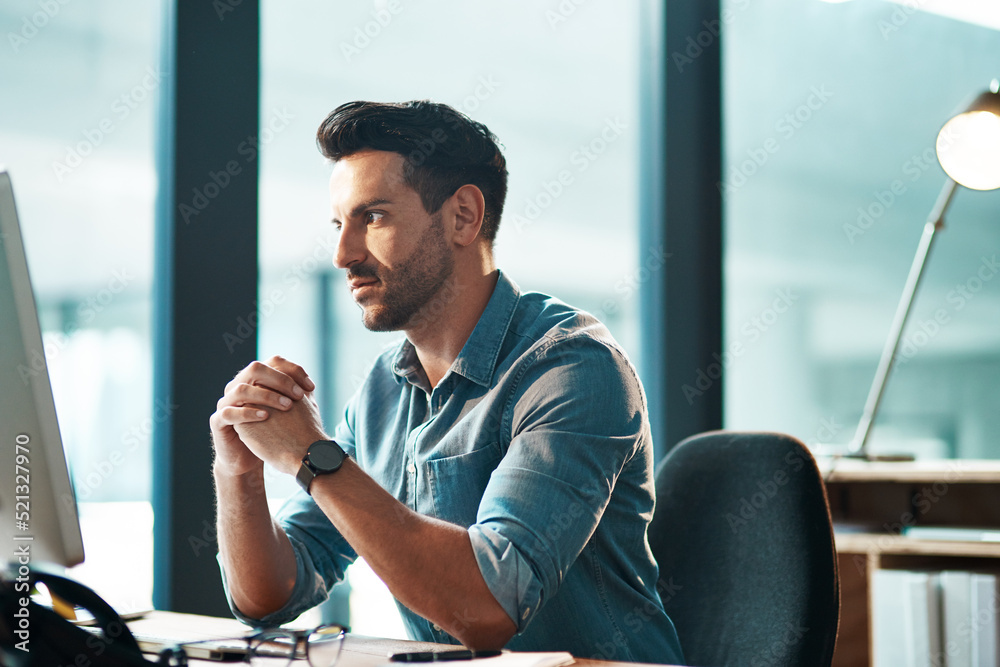 Poster serious, busy and thinking business man working at his computer desk alone inside a modern office ne