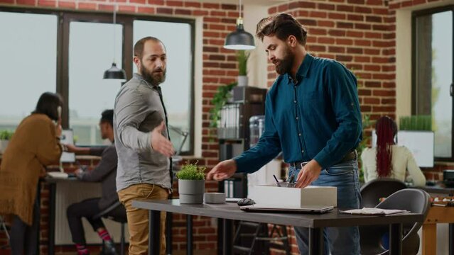 Depressed sad person getting fired from corporate job, packing belongings to leave office. Jobless disappointed man feeling worried about unemployment and career failure, being frustrated.