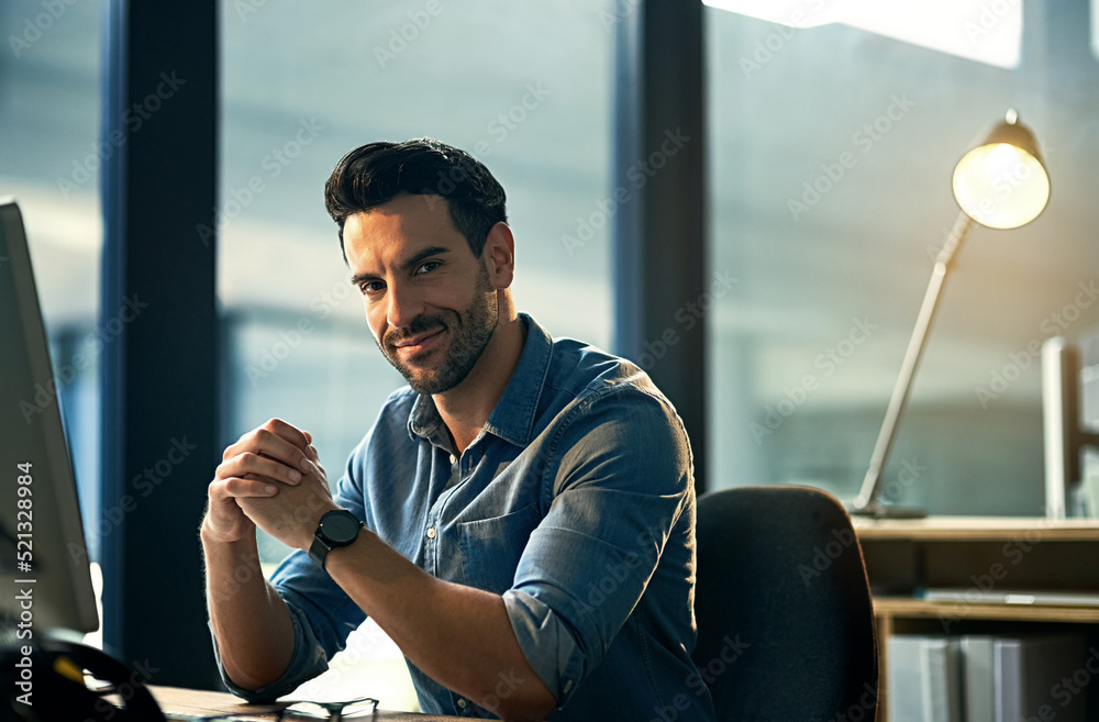 Aufkleber portrait of a young businessman on a computer during a late night at work. confident hardworking man