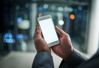 Businessman hands holding phone with white screen template in modern office. Closeup businessperson reading text message on smartphone at night while working overtime at work