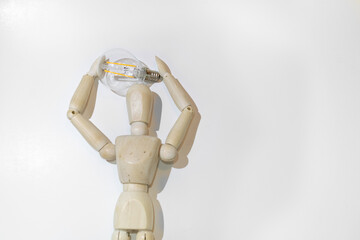 Mannequin Wood Figure carrying an incandescent light bulb. New idea concept. White background
