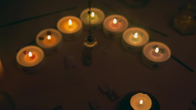 Divination. Mystic esoteric forune telling with spinning crystal quartz pendulum