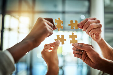 Group of business people holding puzzle pieces. Professionals connect and collaborate together inside office building. Closeup of hands, and team working together on a new strategy for success. - obrazy, fototapety, plakaty
