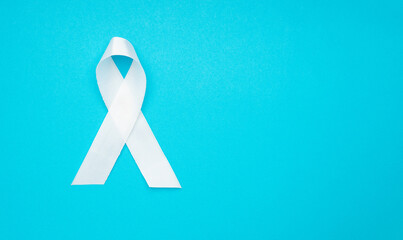 Top view of a white ribbon on a light blue background