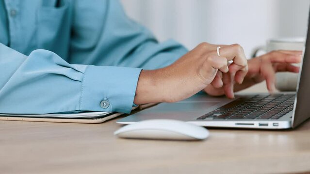 A business woman hands typing on a laptop and clicking a mouse on a work or home office desk. Closeup of female entrepreneur sending and email to colleagues or clients or using the internet.
