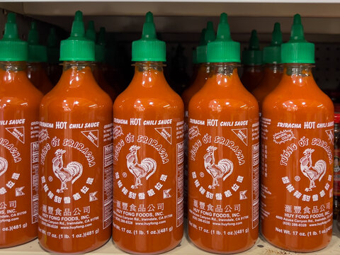 Pearland, TX, USA - March 11, 2022: Hoy Fong Sriracha Hot Chili Sauce, 17 Oz Bottles on the shelf in a supermarket.