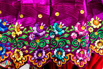 Close up of the skirt with traditional design for Cuenca city and Azuay province of Ecuador. It embroidered with silk thread and adorned with sequins and beads.	