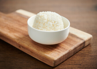 White rice on a wooden table. Selective focus