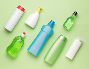 Various cleaning products on a light green background. Cleaning kit.